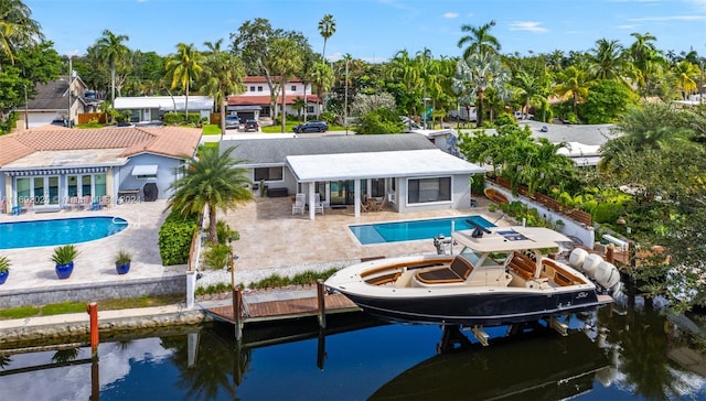 rear view of property with a patio area and a water view