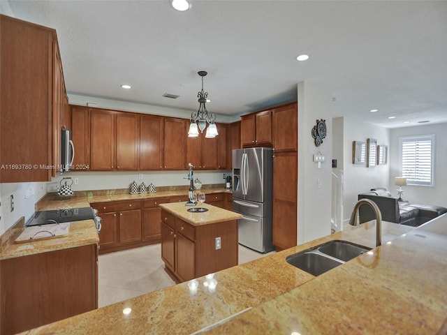 kitchen featuring sink, decorative light fixtures, a center island with sink, light tile patterned flooring, and appliances with stainless steel finishes