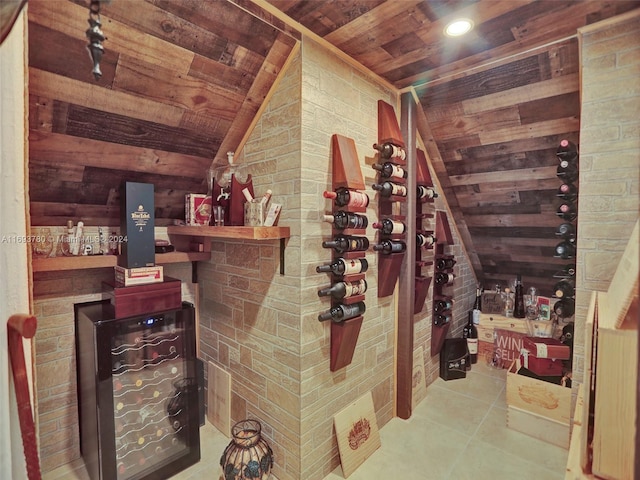 wine cellar with lofted ceiling, tile patterned floors, wooden ceiling, and brick wall