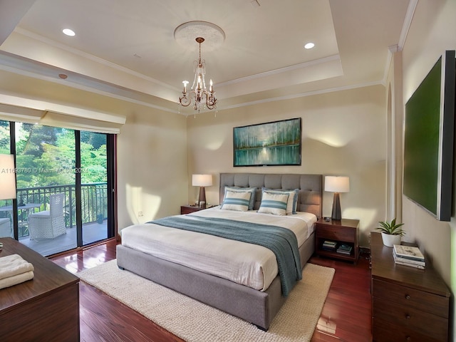 bedroom featuring access to exterior, dark hardwood / wood-style flooring, a raised ceiling, crown molding, and a chandelier