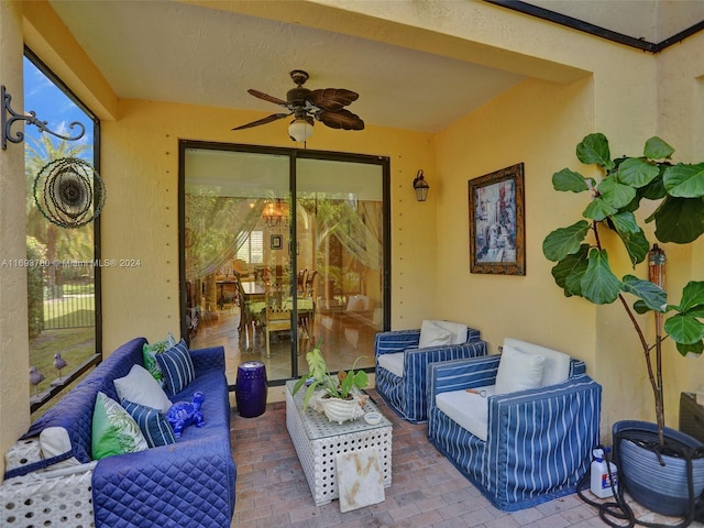 view of patio with an outdoor living space and ceiling fan