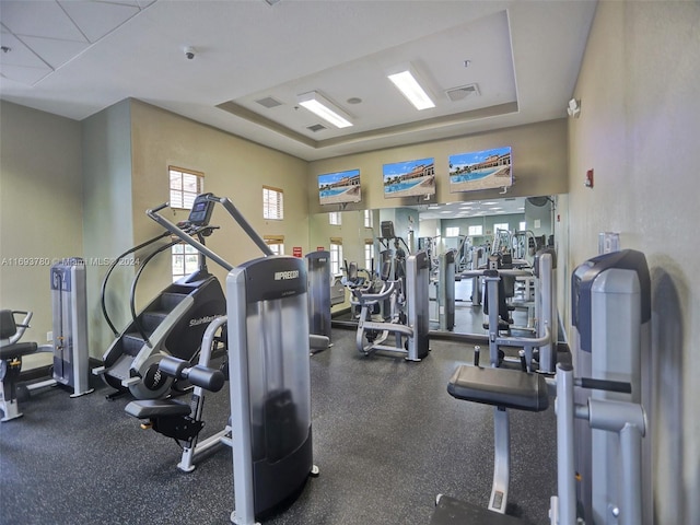 gym featuring a tray ceiling