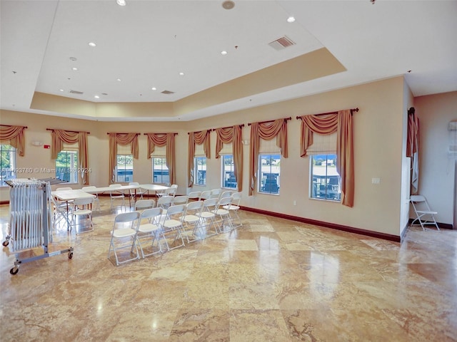 kitchen featuring a tray ceiling and a breakfast bar