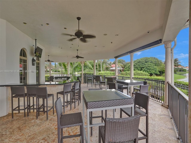 view of patio / terrace featuring ceiling fan and a bar