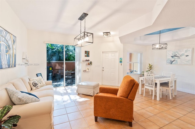 living room featuring a notable chandelier and light tile patterned floors