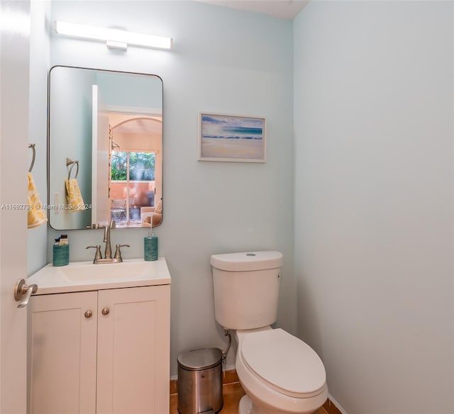 bathroom featuring tile patterned floors, vanity, and toilet