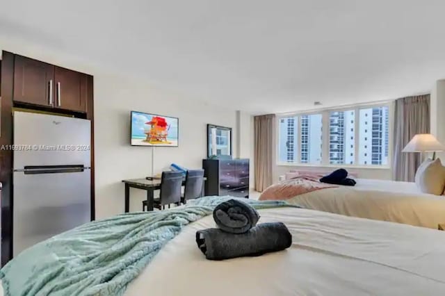 bedroom with stainless steel fridge