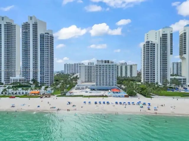 bird's eye view with a view of the beach and a water view