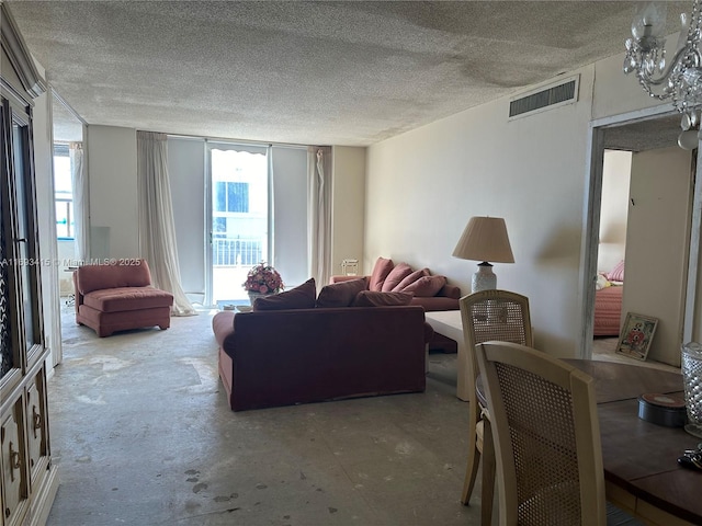 living room with concrete floors and a textured ceiling