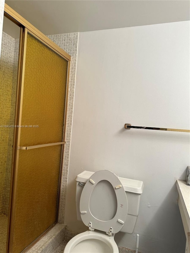 bathroom featuring walk in shower and toilet