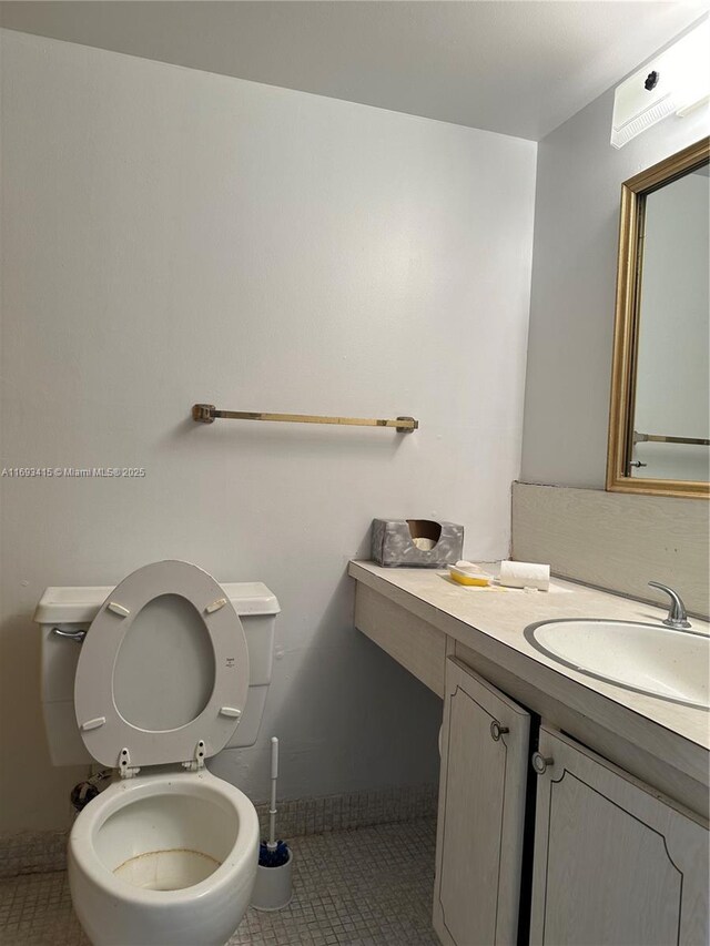 bathroom featuring vanity, tile patterned floors, and toilet