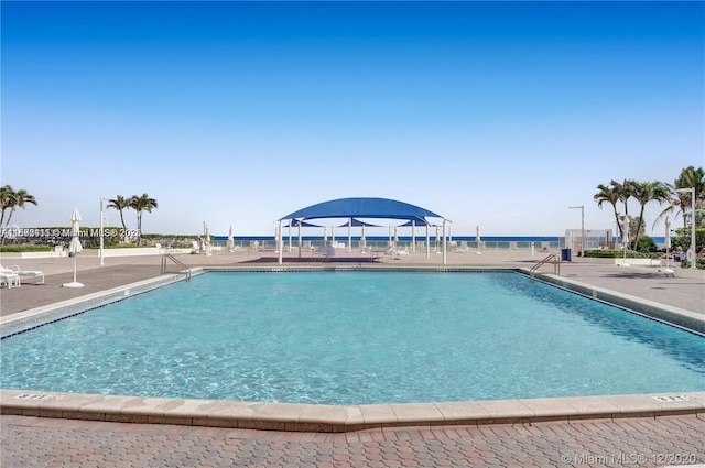 view of swimming pool featuring a patio area