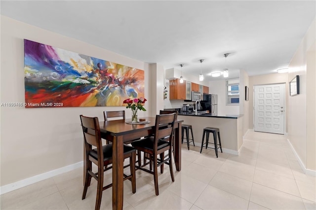 dining space with sink and light tile patterned floors