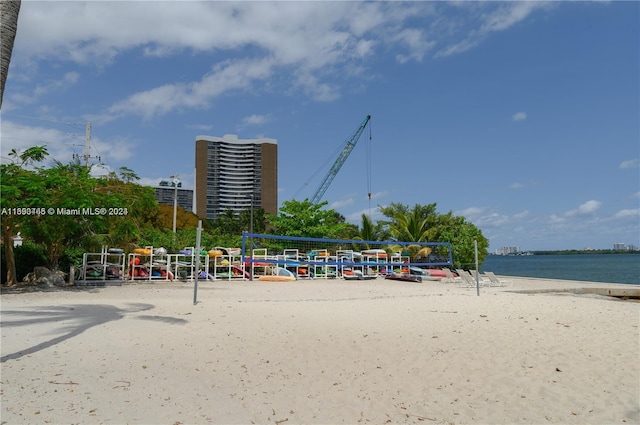 view of property's community featuring a beach view and a water view