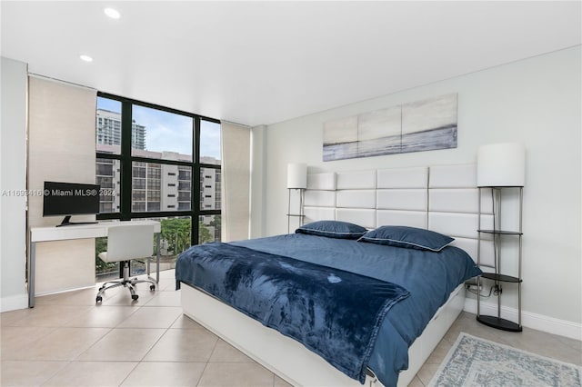 bedroom featuring expansive windows and light tile patterned flooring