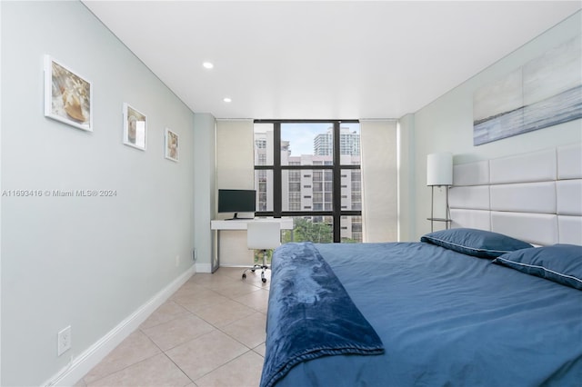 tiled bedroom featuring expansive windows