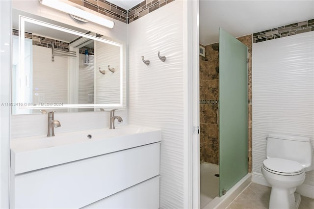 bathroom with an enclosed shower, vanity, tile walls, tile patterned flooring, and toilet