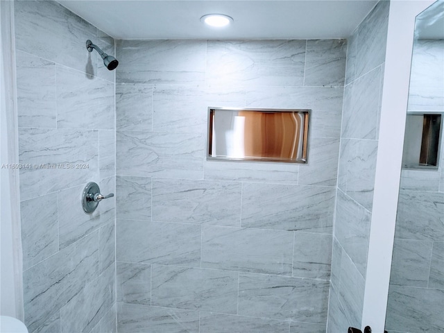 bathroom with tiled shower