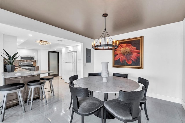 dining space featuring a chandelier, light tile patterned floors, and electric panel