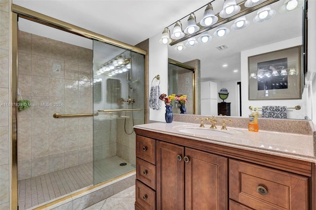 bathroom featuring tile patterned flooring, vanity, and a shower with door