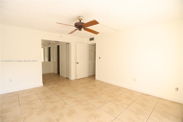 unfurnished room featuring ceiling fan and light tile patterned flooring