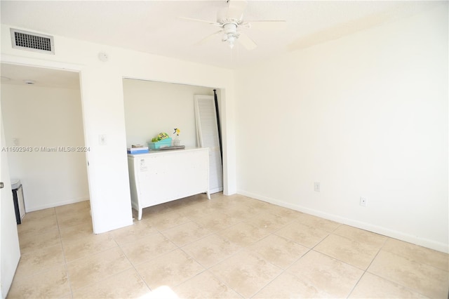 unfurnished bedroom with ceiling fan and light tile patterned flooring