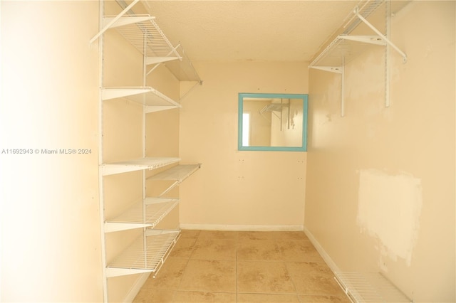 spacious closet featuring tile patterned floors