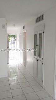 hallway with tile patterned flooring