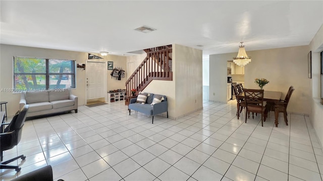 living room featuring light tile patterned floors and a notable chandelier