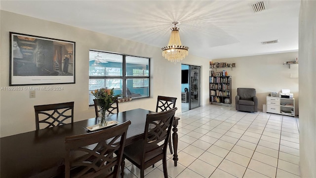 tiled dining space with a notable chandelier