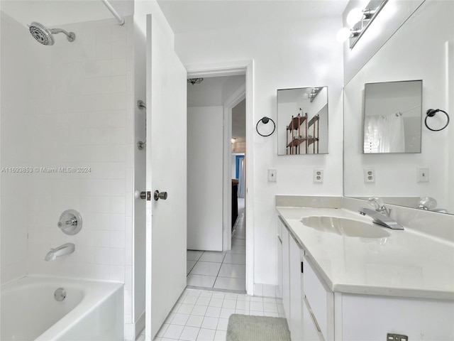 bathroom with tile patterned flooring, vanity, and tiled shower / bath