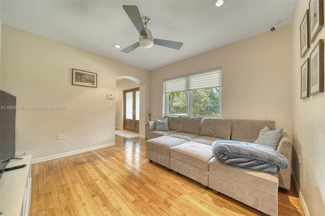 living room featuring light wood-type flooring and ceiling fan