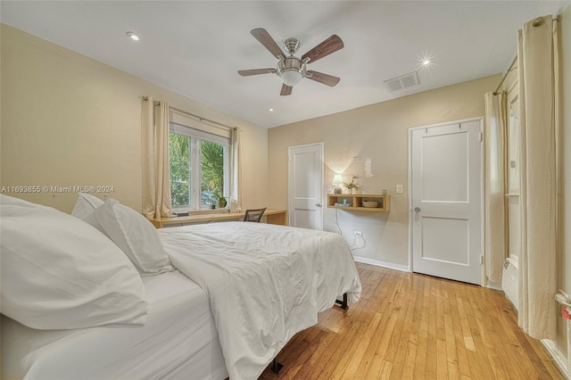 bedroom with light wood-type flooring and ceiling fan