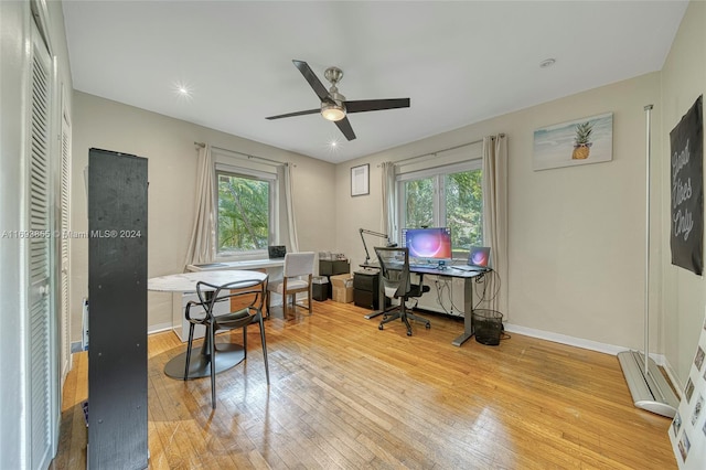 office with light hardwood / wood-style floors and ceiling fan