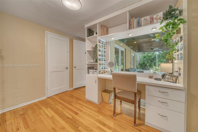 office featuring light hardwood / wood-style flooring and a textured ceiling