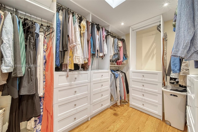 walk in closet with light wood-type flooring