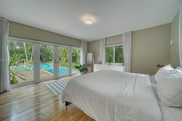 bedroom with access to outside, french doors, and light hardwood / wood-style floors