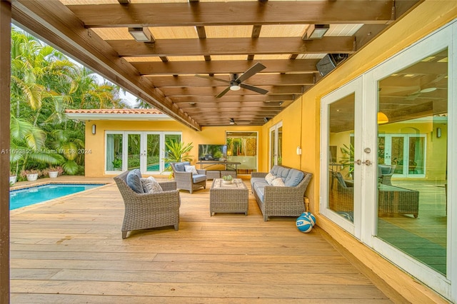 wooden terrace featuring ceiling fan, an outdoor hangout area, and french doors