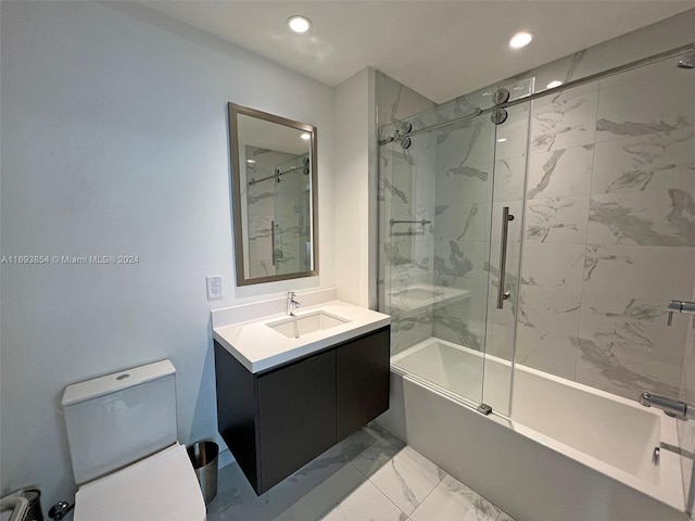 full bathroom featuring combined bath / shower with glass door, vanity, and toilet