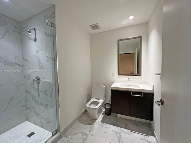 bathroom with vanity, toilet, and a shower with door