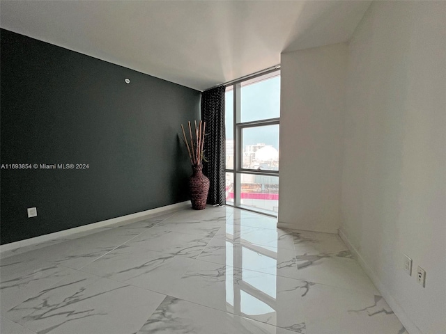 unfurnished room with expansive windows