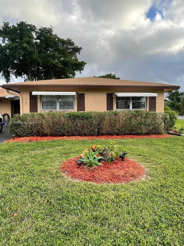 718 Whippoorwill Ln, Delray Beach, FL 33445 - single story home with stucco siding and a front yard