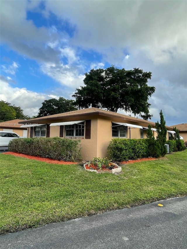 view of property exterior featuring a lawn