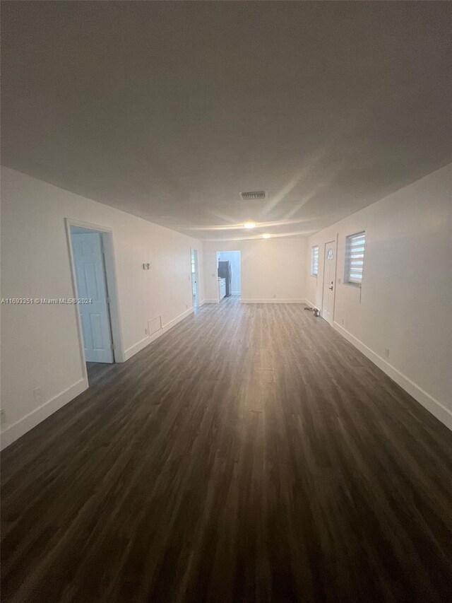 718 Whippoorwill Ln, Delray Beach, FL 33445 - empty room with dark wood finished floors and baseboards