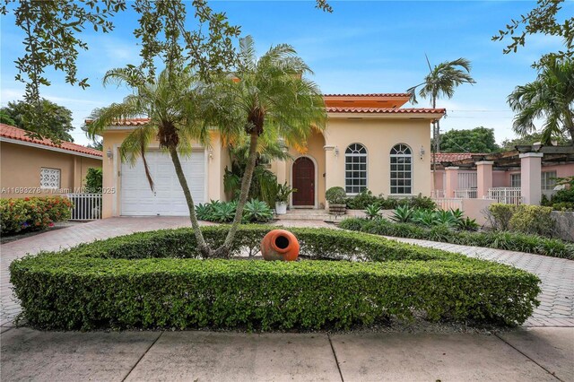 mediterranean / spanish house with a garage