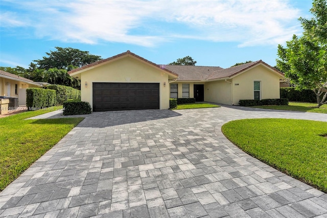 ranch-style home featuring a garage and a front lawn