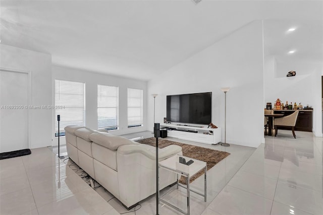 living room featuring light tile patterned flooring and vaulted ceiling