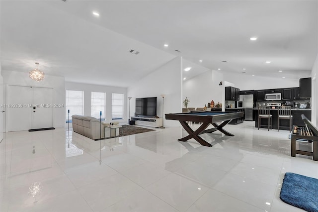 tiled living room featuring a chandelier, lofted ceiling, and pool table