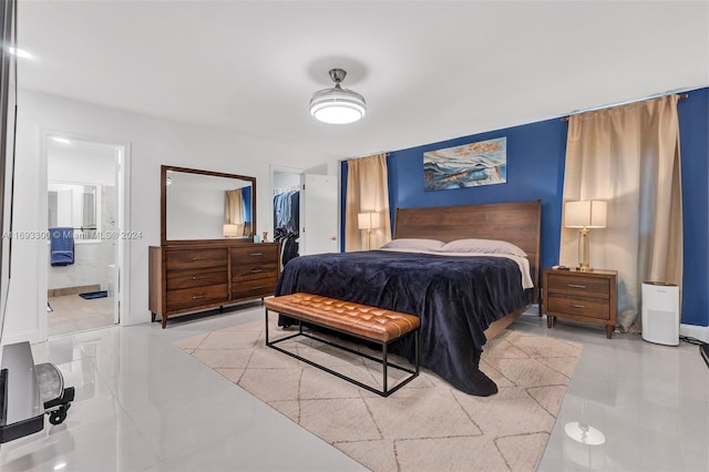 bedroom with a closet, a spacious closet, and ensuite bath