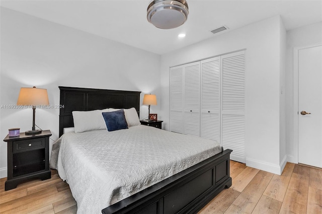 bedroom featuring a closet and light wood-type flooring